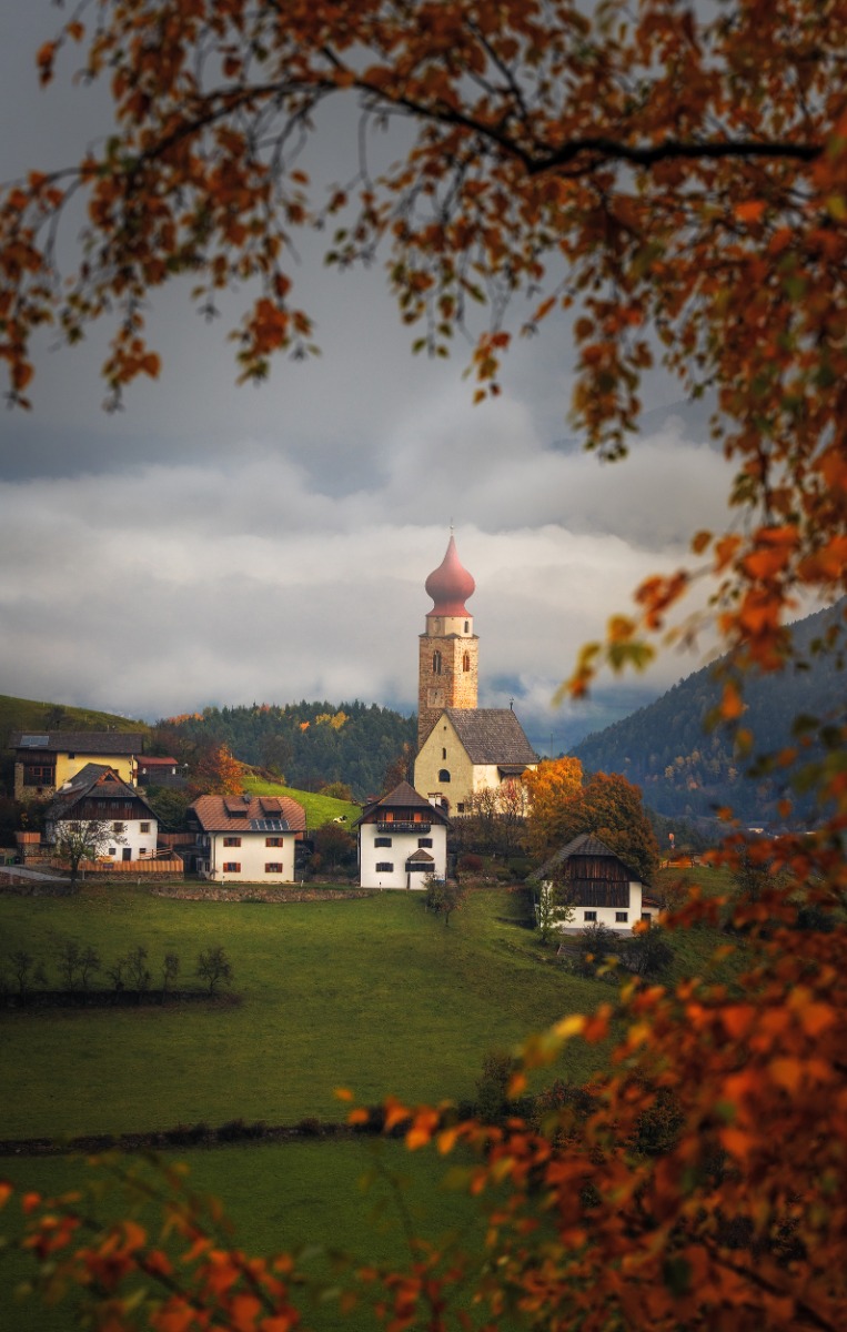 a-small-church-seen-though-a-gap-in-the-trees