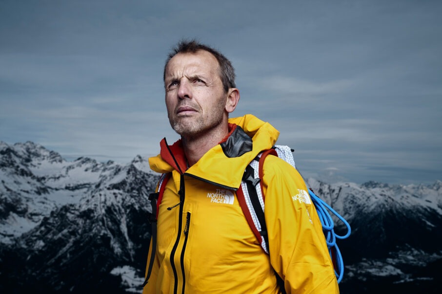 man-wearing-a-yellow-coat-on-top-of-a-mountain_wresized_w906